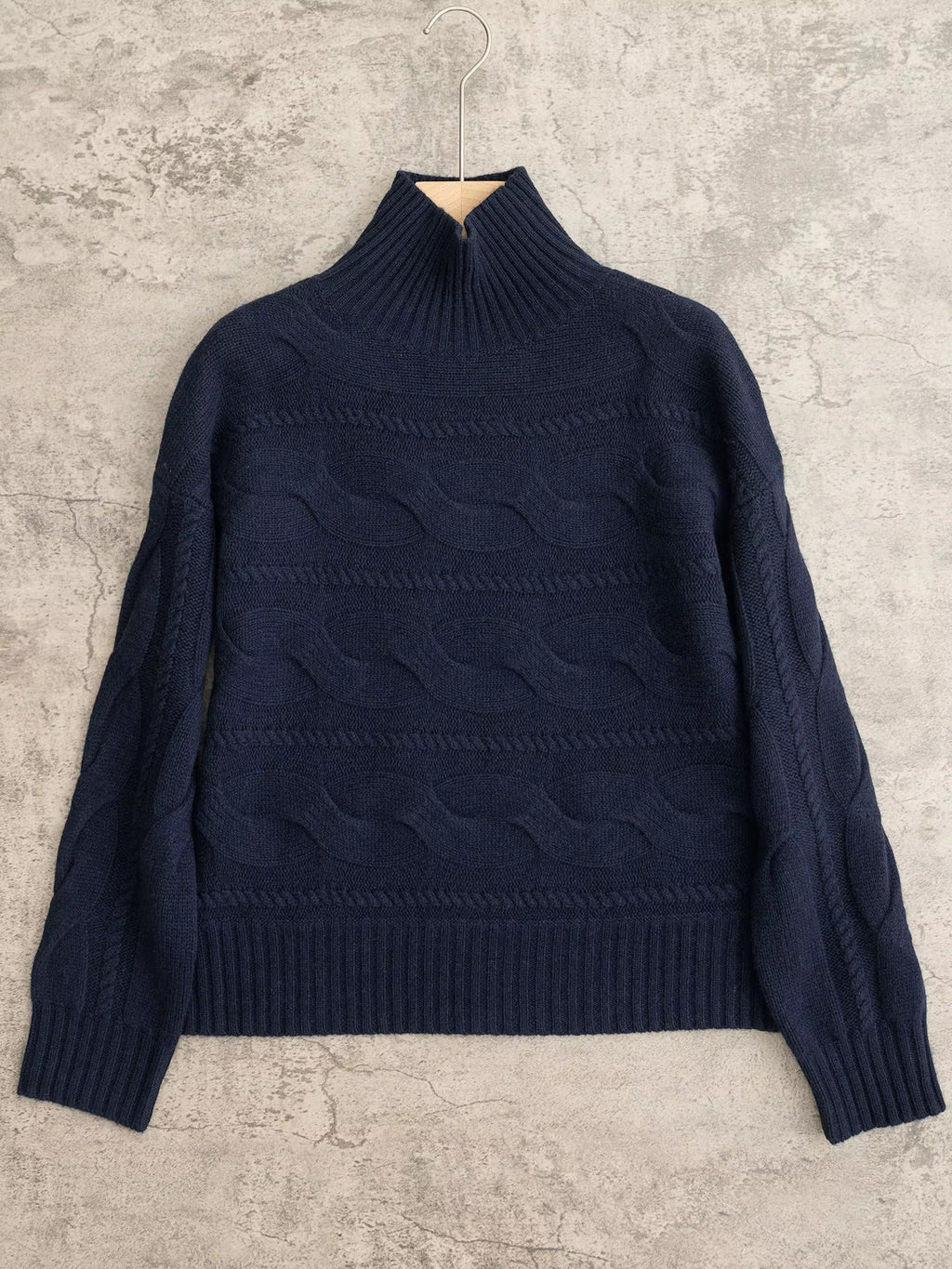 Women's navy blue cable-knit turtleneck jumper